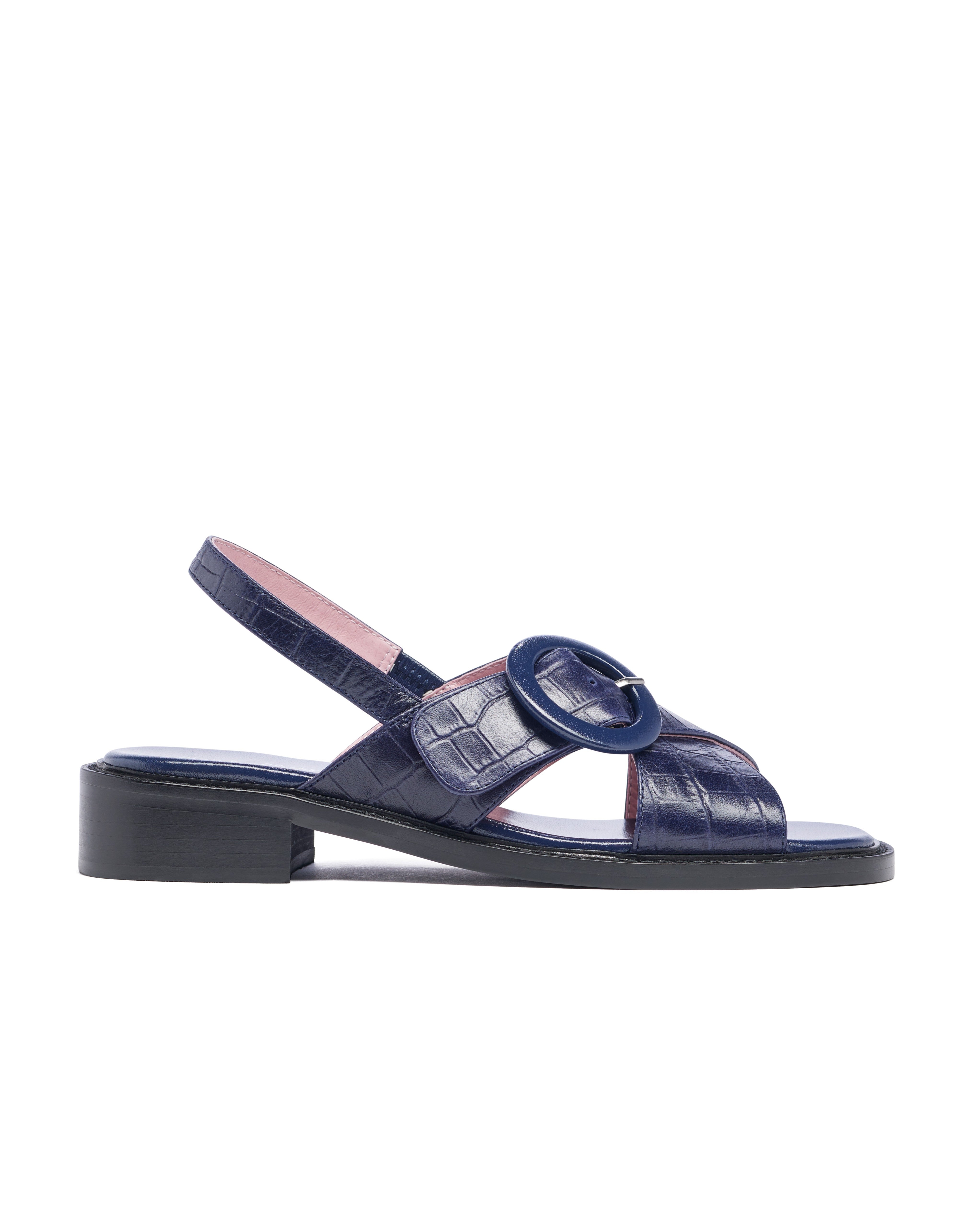 Navy blue sandal with pink interior on a white background