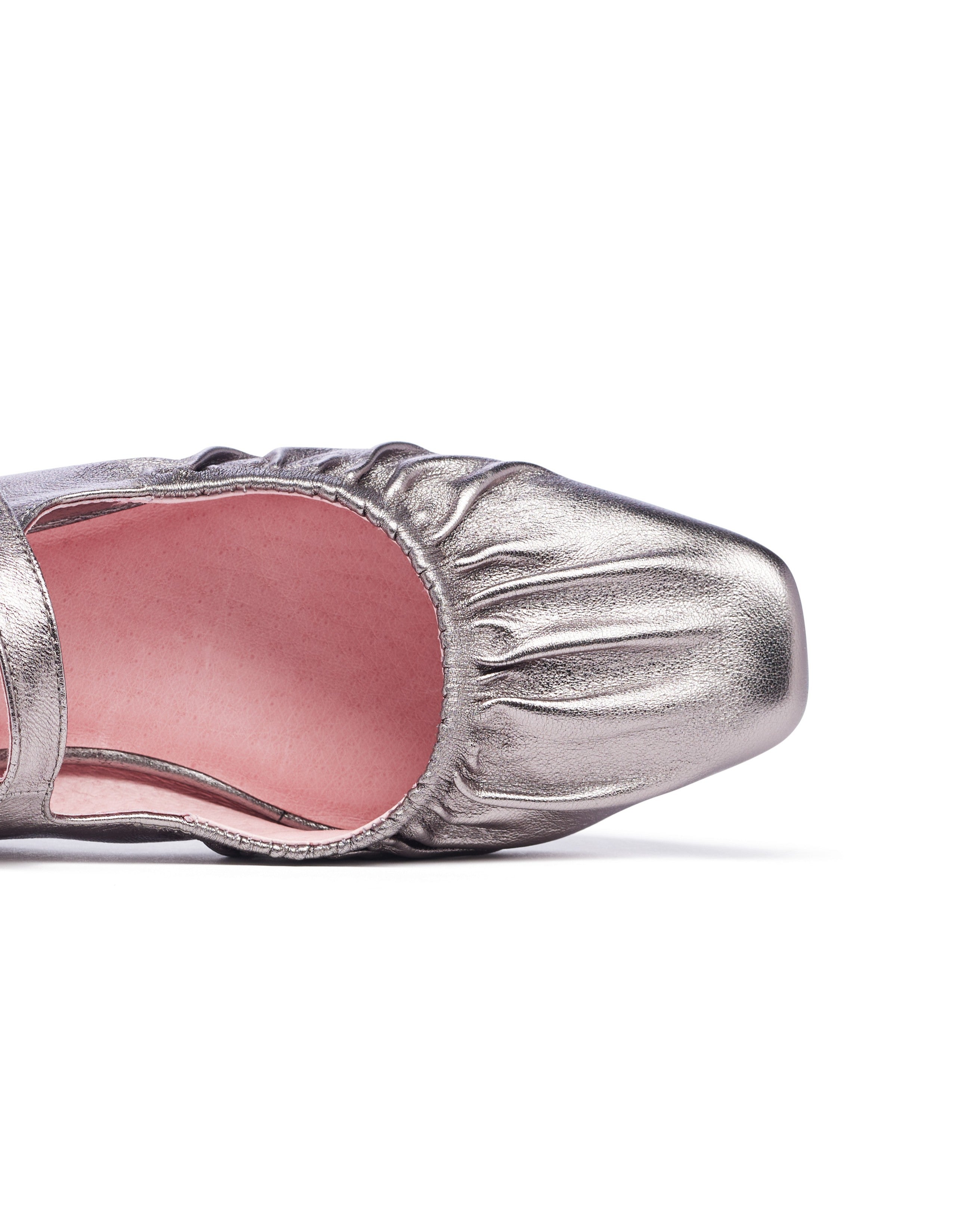Silver shoe with pink interior on a white background